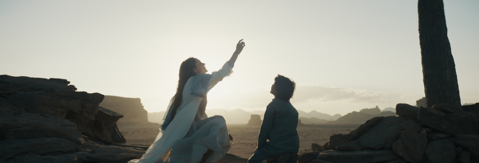 A mother and son beneath the desert sky in The Lamb