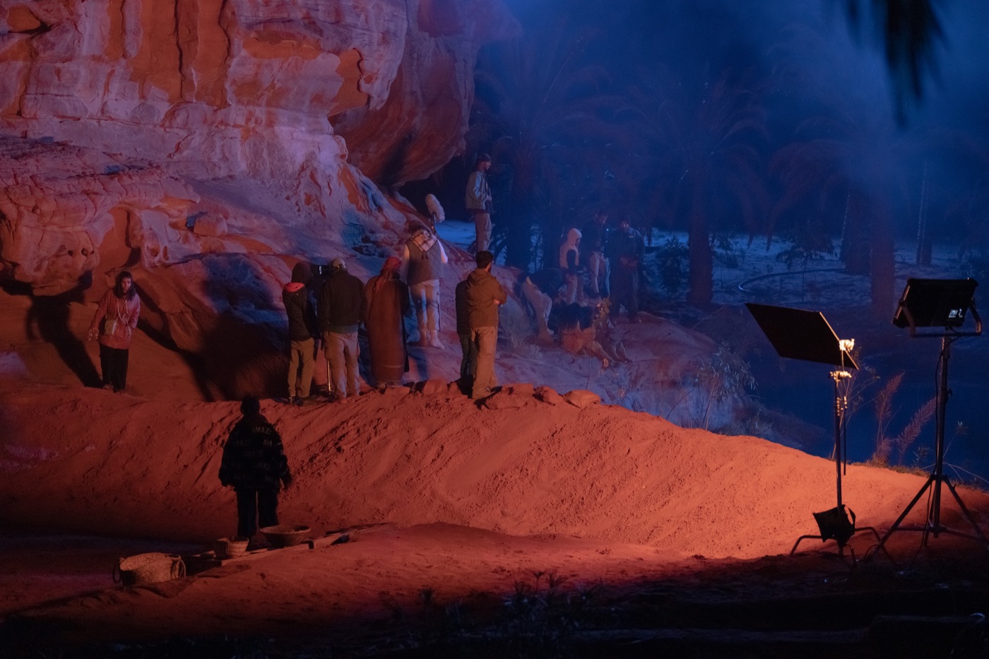The Lamb crew filming at night among red canyon walls